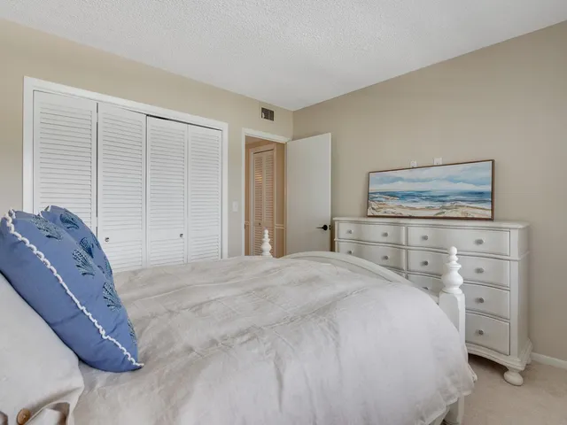 a bedroom with a bed and dresser