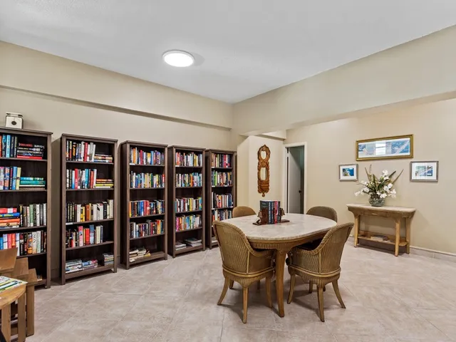 a view of a dining room with furniture and a book shelf