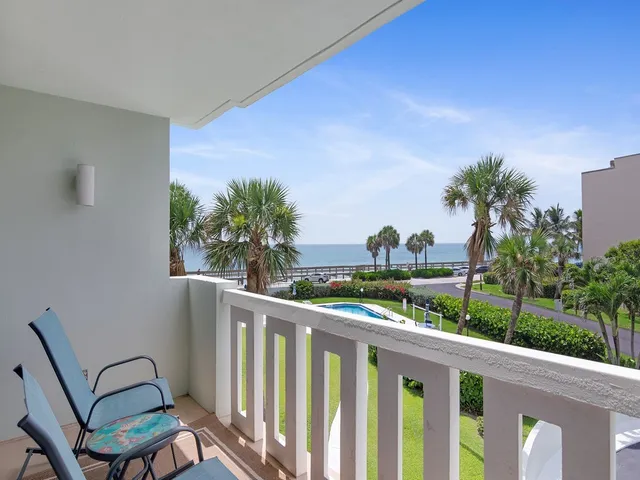 a view of a chairs and table in patio of wooden house