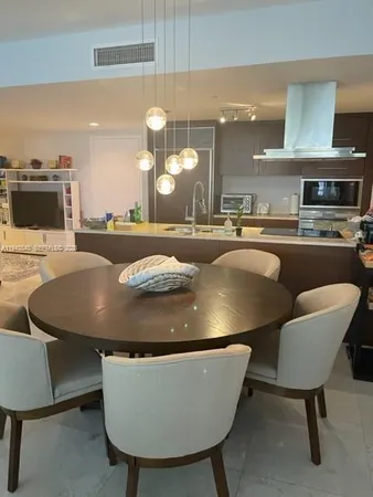 a room with dining table and chairs