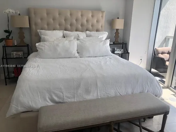a large white bed in a white room
