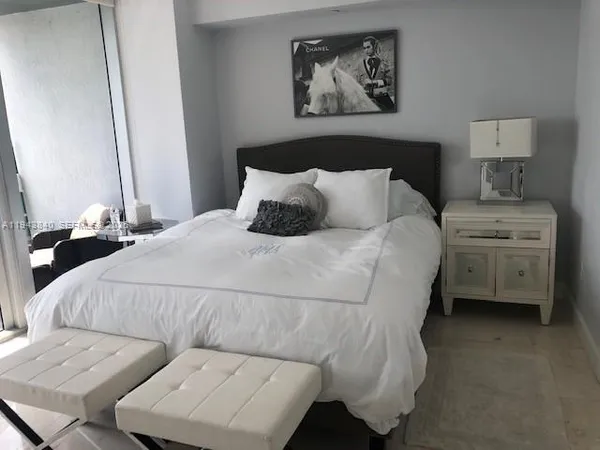 a bedroom with a bed and a couch