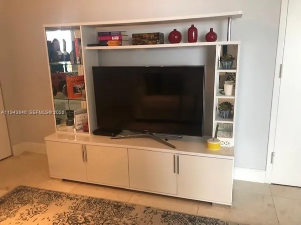 a living room with a fireplace furniture and a flat screen tv