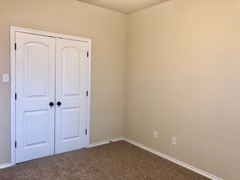 a view of a backyard with a wooden fence