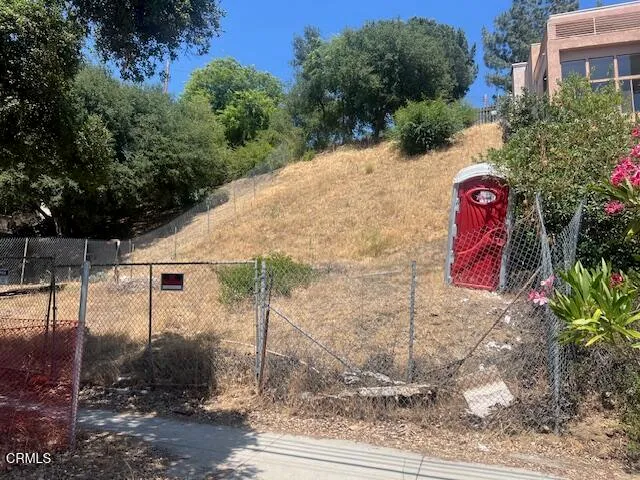 a view of a wooden house with a yard