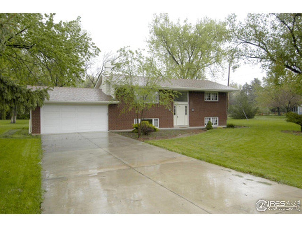 7631 Baseline Road Boulder, CO 80303 - Photo 3 of 12 a front view of a house with a yard and trees