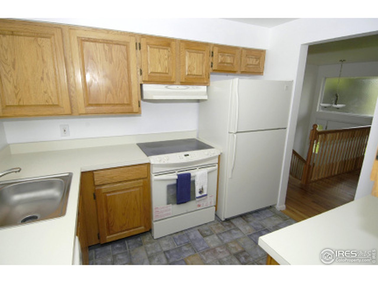 7631 Baseline Road Boulder, CO 80303 - Photo 4 of 12 a kitchen with a refrigerator sink and cabinets