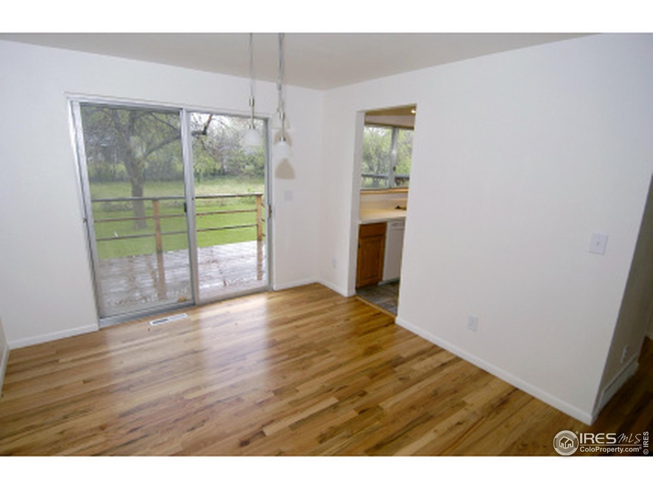 7631 Baseline Road Boulder, CO 80303 - Photo 6 of 12 a view of empty room with wooden floor and fan