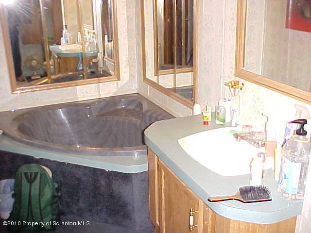 Lot #65 Pride Manor Conklin, NY 13748 - Photo 5 of 6 a bathroom with a tub and a window