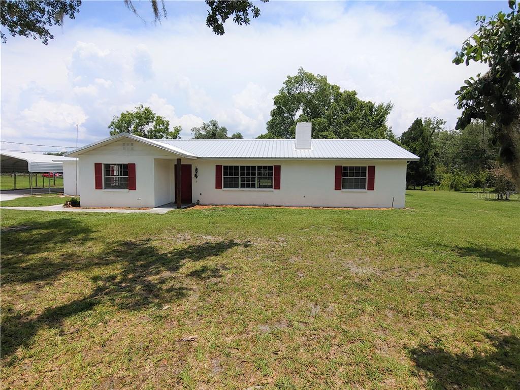 6908 Kinard Road Plant City, FL 33565 - Photo 1 of 1 a front view of house with yard and green space