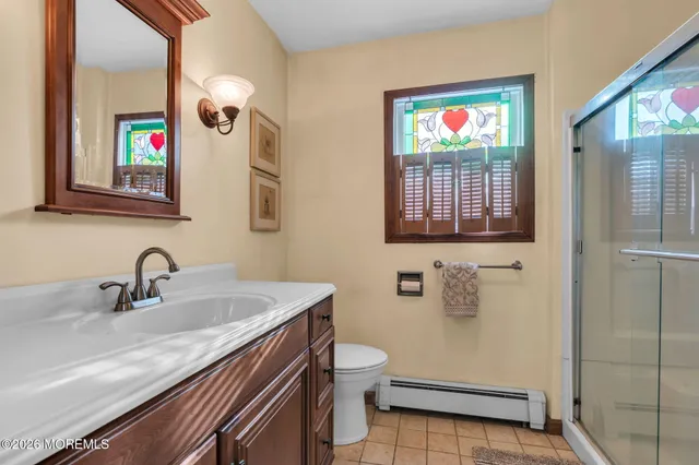 a bathroom with a sink a toilet and mirror