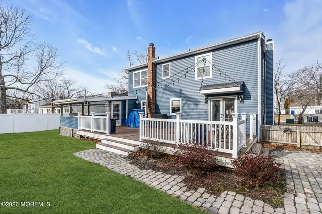 a view of a house with a yard and deck