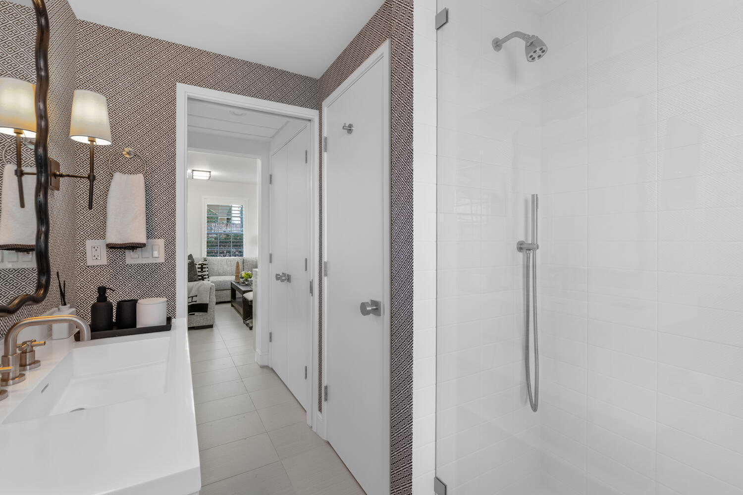 134 Peruvian Avenue, Unit 104 Palm Beach, FL 33480 - Photo 14 of 20 a bathroom with a double vanity sink a toilet a mirror and shower