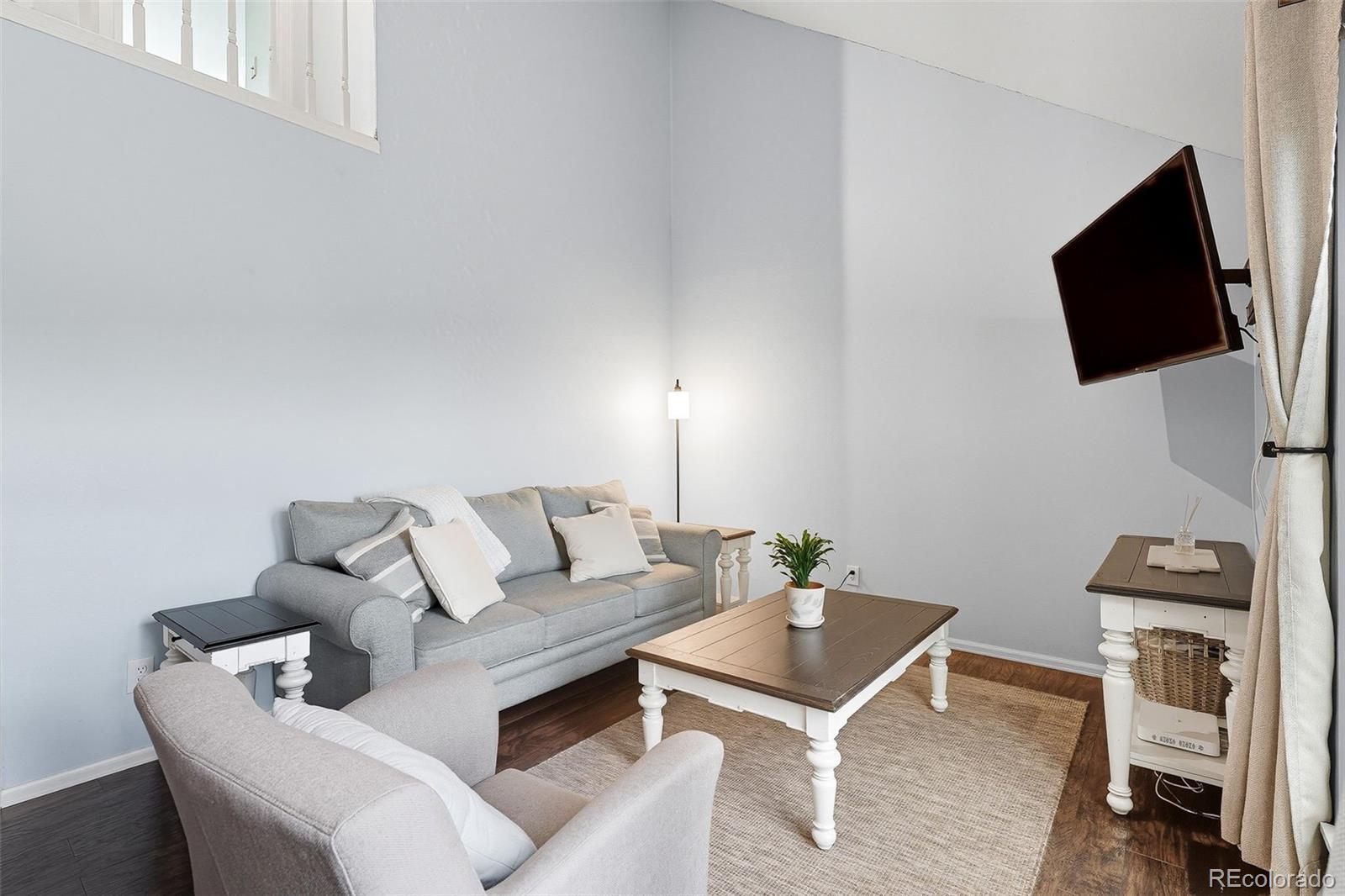 6080 Fenton Street Arvada, CO 80003 - Photo 12 of 48 a living room with furniture and a flat screen tv