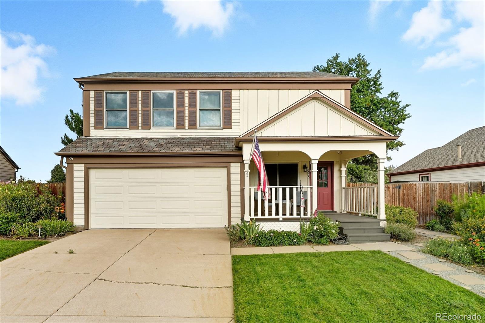 6080 Fenton Street Arvada, CO 80003 - Photo 2 of 48 a front view of a house with a yard and garage