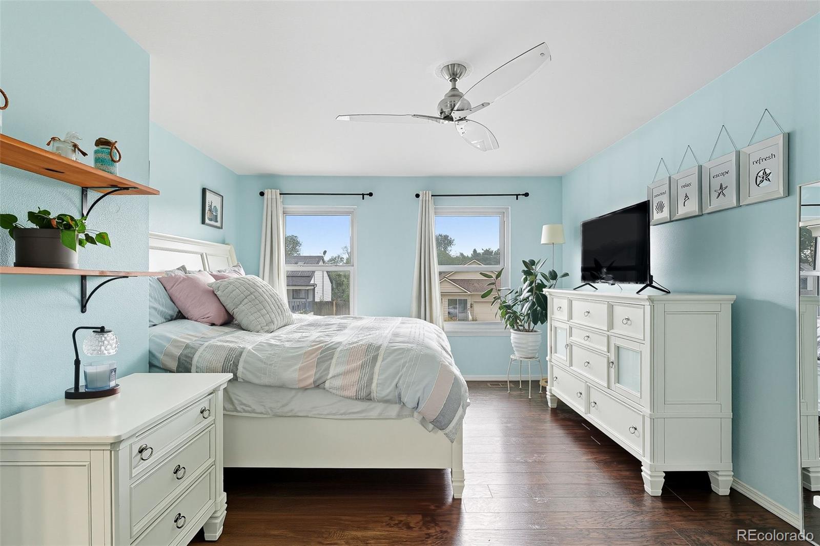 6080 Fenton Street Arvada, CO 80003 - Photo 27 of 48 a room with a bed and flat tv screen on the dresser