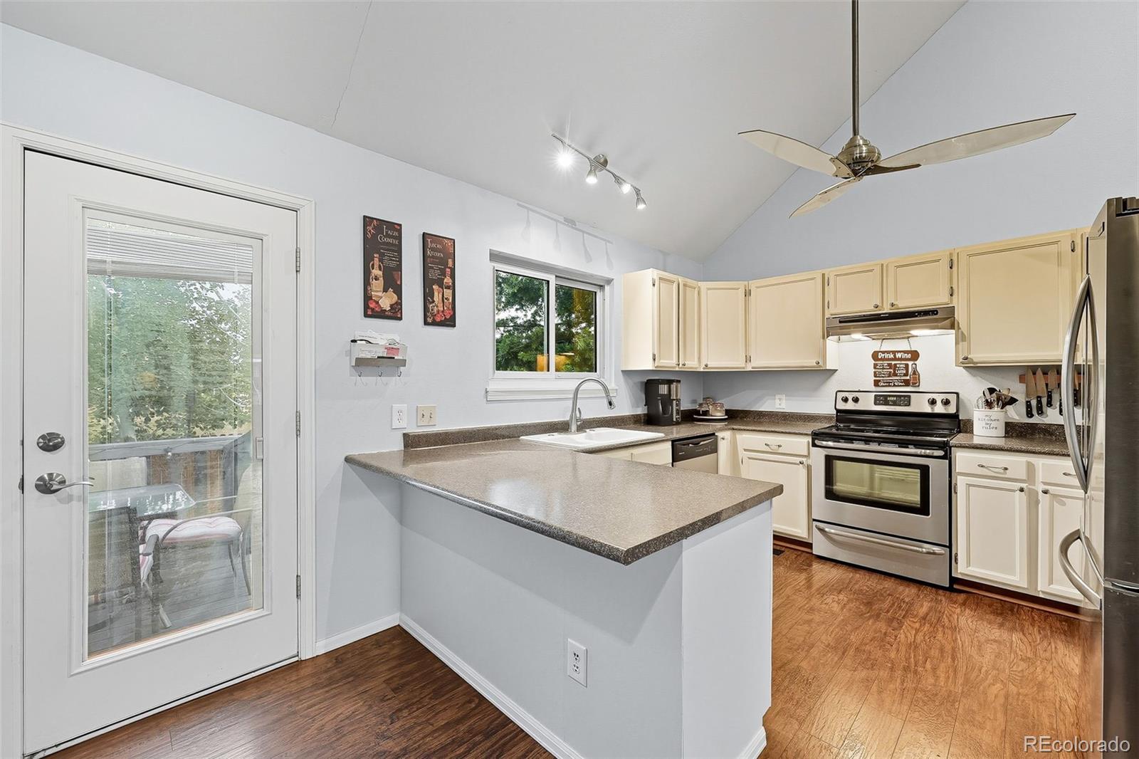 6080 Fenton Street Arvada, CO 80003 - Photo 3 of 48 a kitchen with stainless steel appliances granite countertop a sink stove and refrigerator