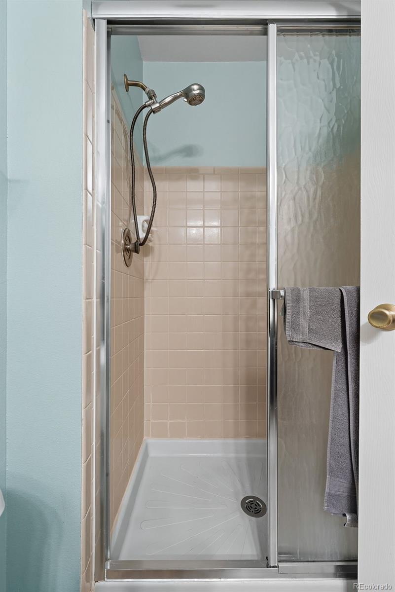 6080 Fenton Street Arvada, CO 80003 - Photo 31 of 48 a bathroom with a glass shower door