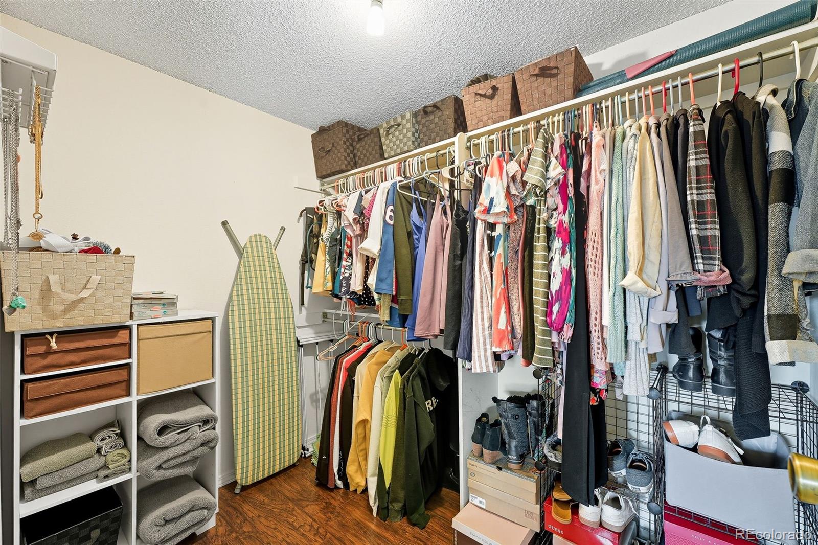 6080 Fenton Street Arvada, CO 80003 - Photo 32 of 48 a view of walk in closet with clothes and shoes