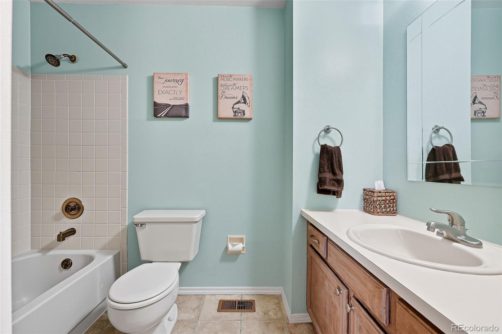 6080 Fenton Street Arvada, CO 80003 - Photo 40 of 48 a bathroom with a granite countertop toilet a sink and a bathtub