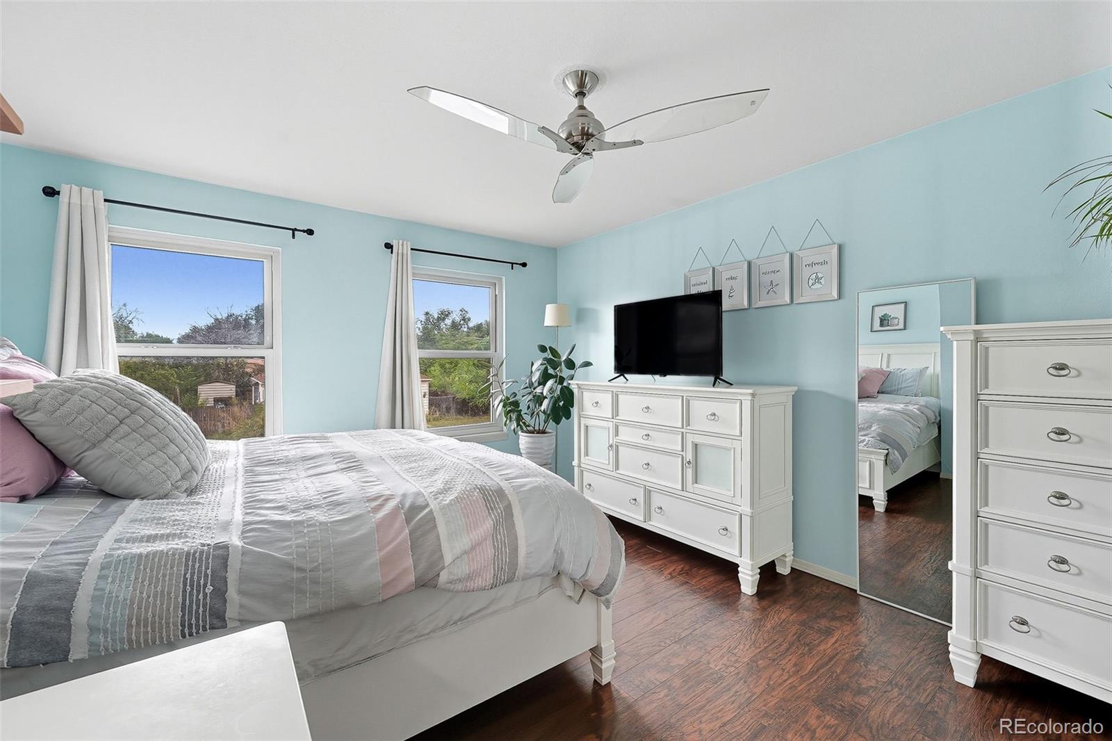 6080 Fenton Street Arvada, CO 80003 - Photo 4 of 48 a bedroom with a bed and a flat screen tv