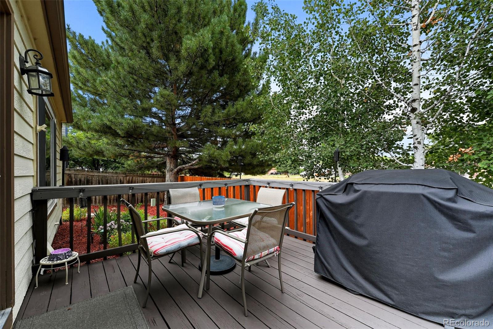 6080 Fenton Street Arvada, CO 80003 - Photo 42 of 48 a view of deck with furniture and trees