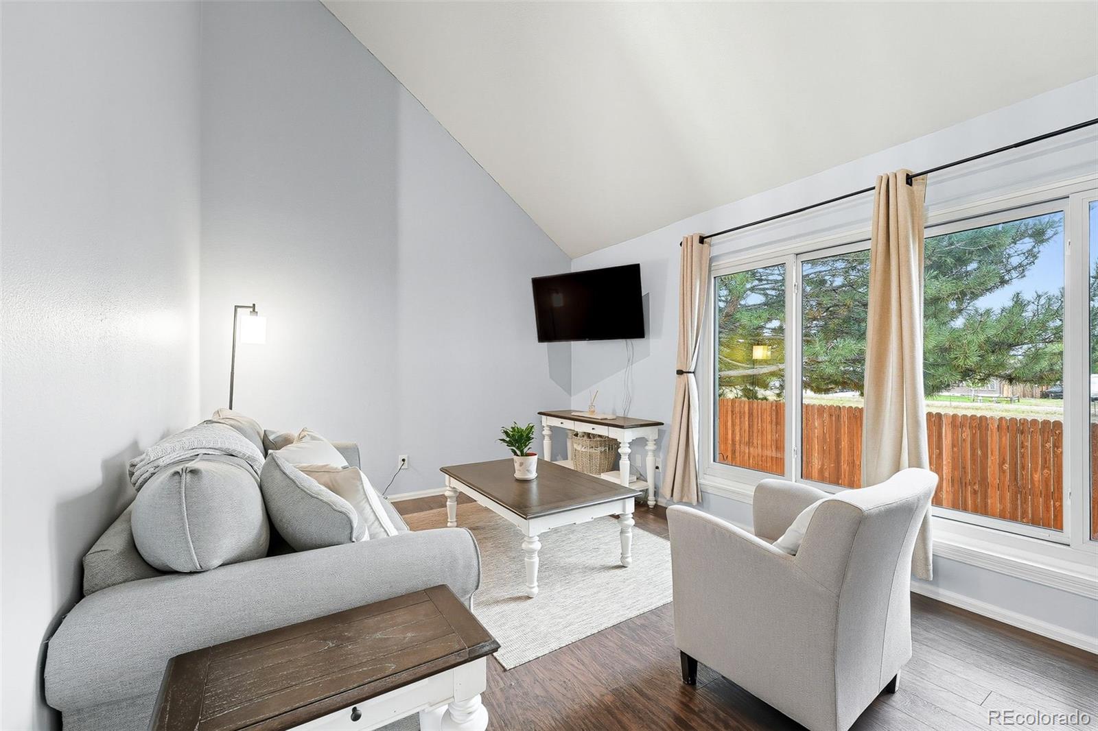 6080 Fenton Street Arvada, CO 80003 - Photo 6 of 48 a living room with furniture and a flat screen tv