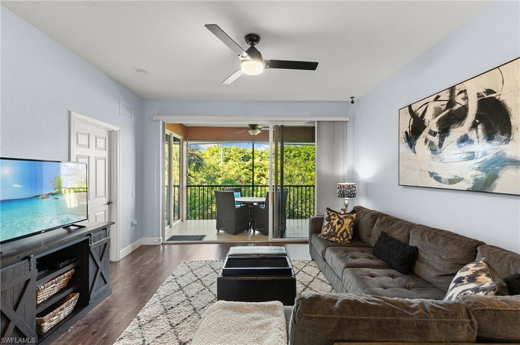 10021 Heather Lane, Unit 803 Naples, FL 34119 - Photo 12 of 41 a living room with furniture and a flat screen tv