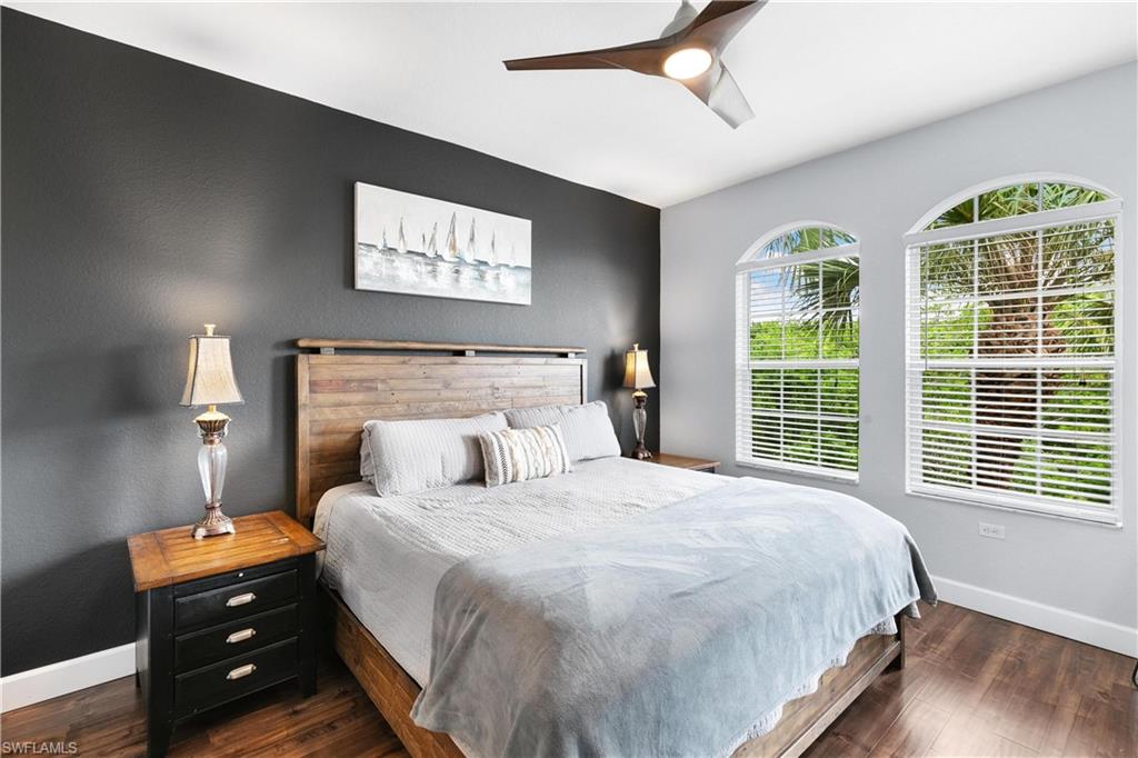 10021 Heather Lane, Unit 803 Naples, FL 34119 - Photo 14 of 41 a bedroom with a bed and a large window