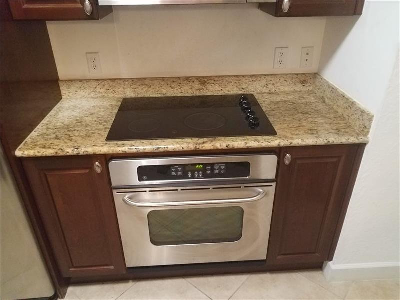1 Renaissance Way, Unit 106 Boynton Beach, FL 33426 - Photo 21 of 31 a stove top oven sitting inside of a kitchen