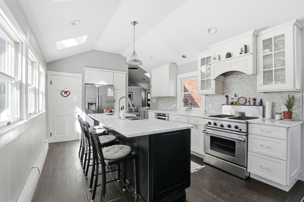 327 Country Way Scituate, MA 02066 - Photo 12 of 39 a kitchen with stainless steel appliances a stove a sink and a refrigerator