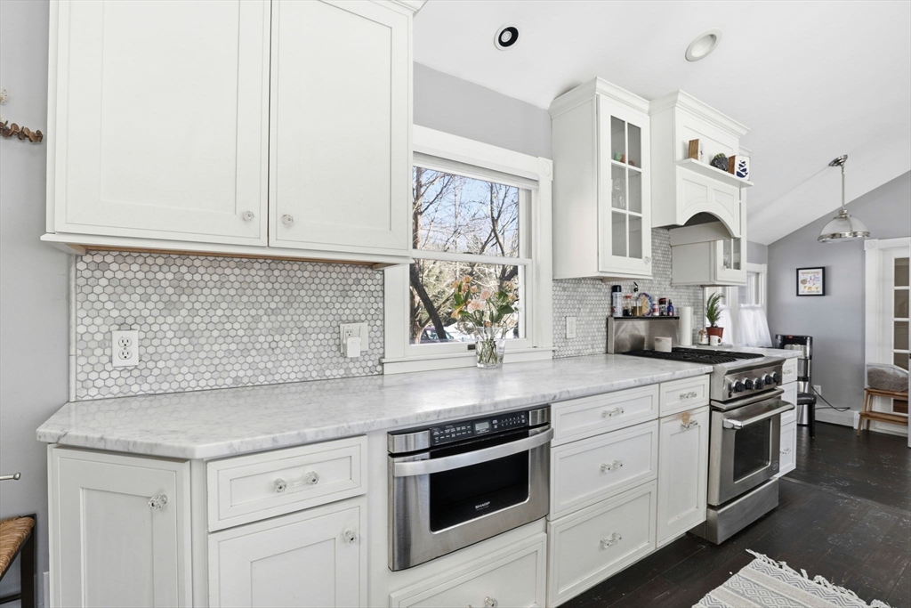327 Country Way Scituate, MA 02066 - Photo 13 of 39 a kitchen with stainless steel appliances granite countertop white cabinets and white appliances