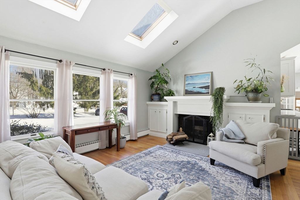 327 Country Way Scituate, MA 02066 - Photo 18 of 39 a living room with furniture a fireplace and a large window