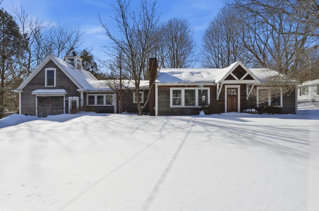 327 Country Way Scituate, MA 02066 - Photo 2 of 39 a front view of a house with a yard covered in snow