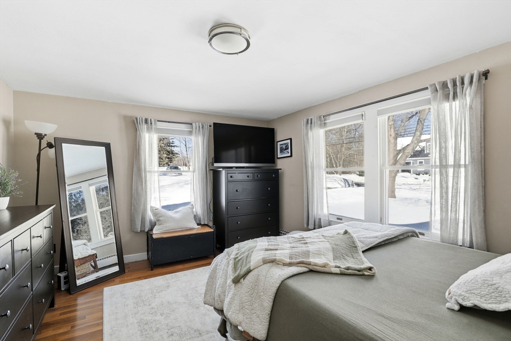 327 Country Way Scituate, MA 02066 - Photo 21 of 39 a bedroom with a bed flat screen tv and a large window