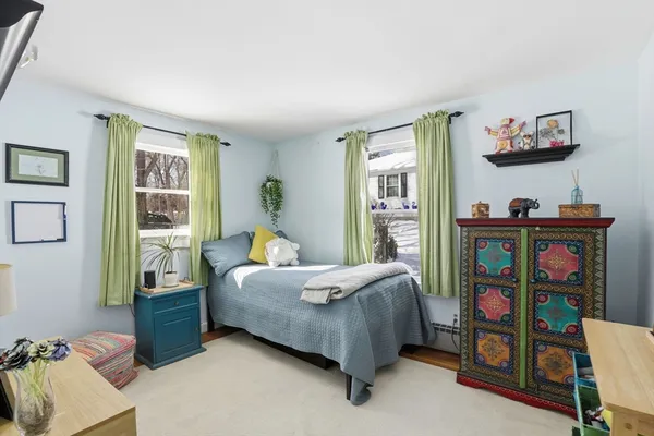 a bedroom with bed and a window