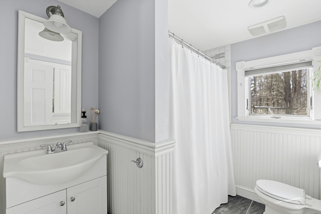 327 Country Way Scituate, MA 02066 - Photo 25 of 39 a bathroom with a sink a toilet and a mirror
