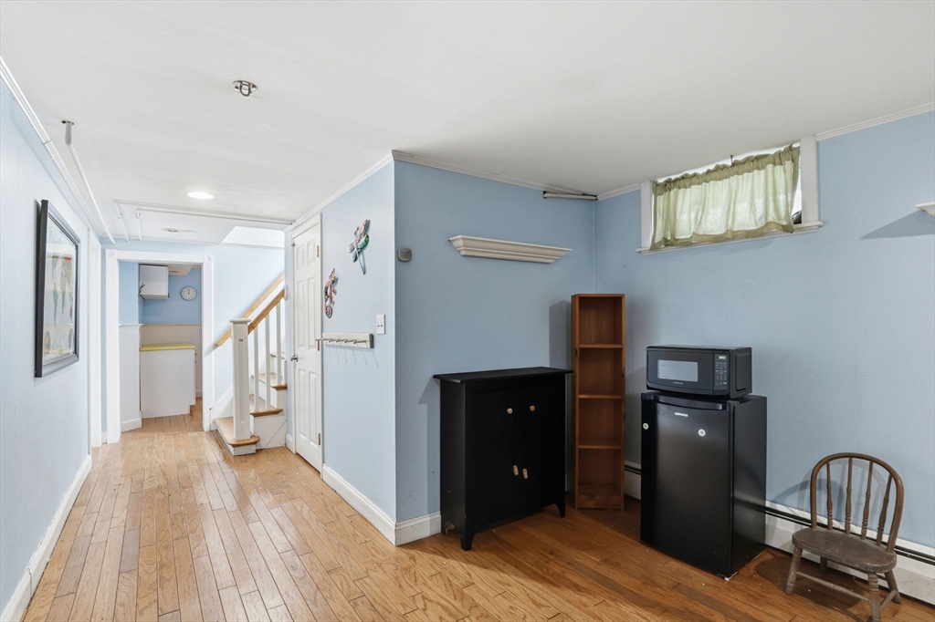 327 Country Way Scituate, MA 02066 - Photo 26 of 39 a view of a hallway with wooden floor and cabinet