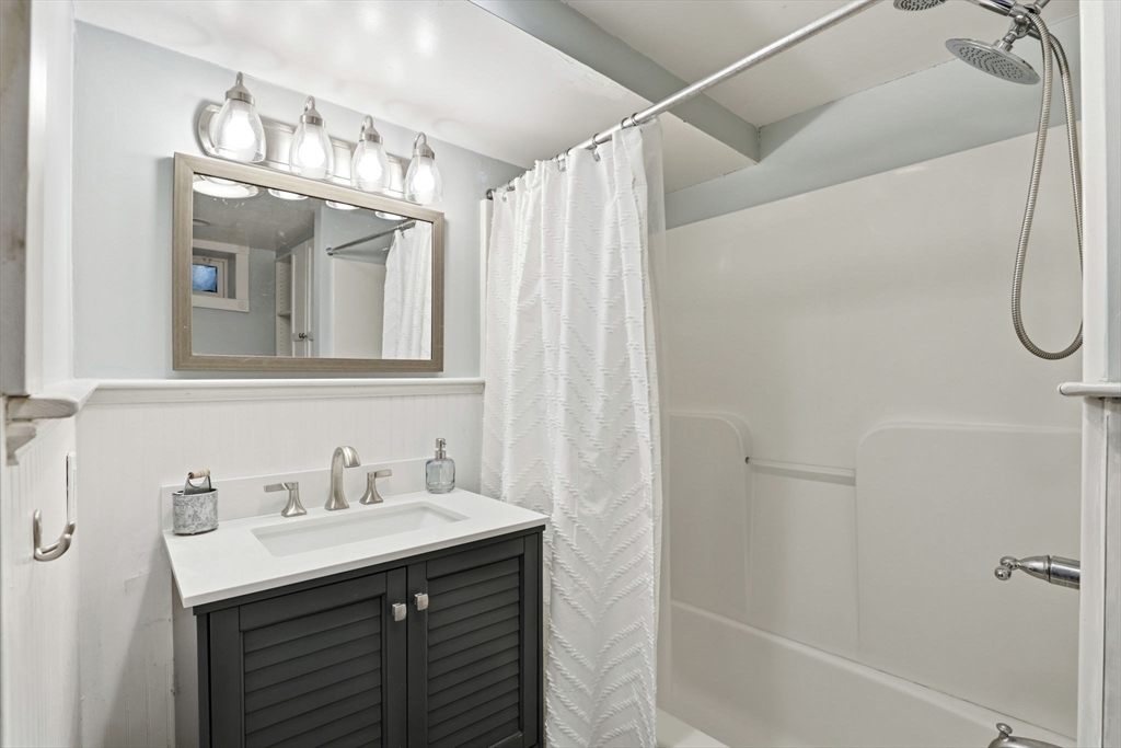 327 Country Way Scituate, MA 02066 - Photo 29 of 39 a bathroom with a sink double vanity and a mirror