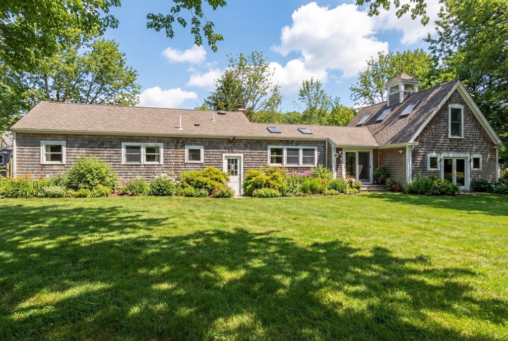 327 Country Way Scituate, MA 02066 - Photo 31 of 39 a front view of a house with a garden