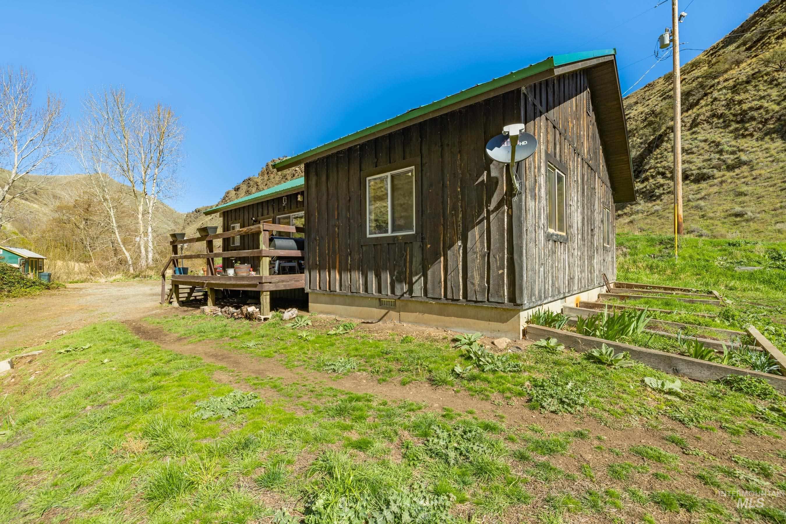 221 Seven Devils Road Riggins, ID 83549 - Photo 38 of 46 View of side of property with a deck with mountain view
