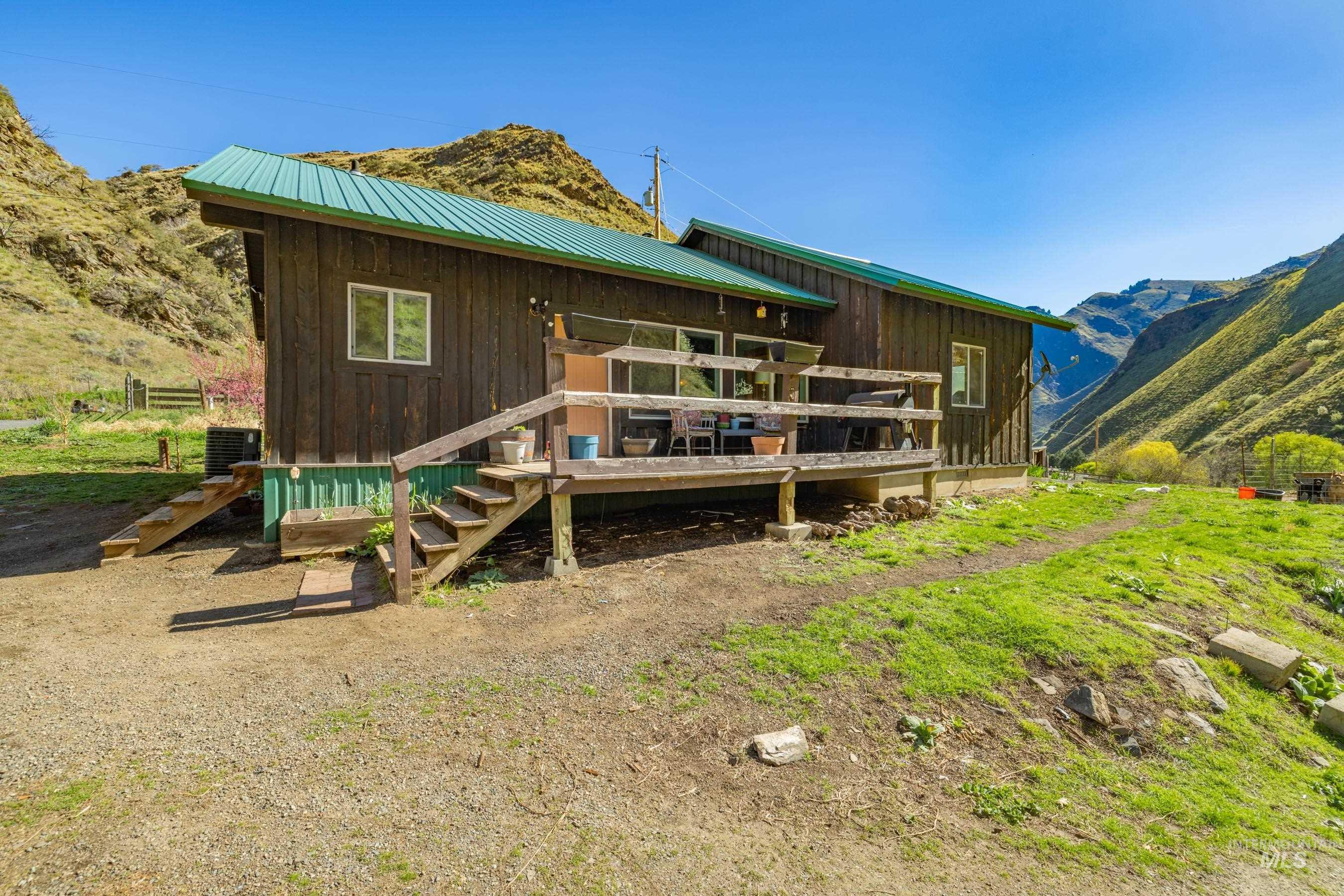 221 Seven Devils Road Riggins, ID 83549 - Photo 4 of 46 Rear view of property featuring a metal roof and a mountain view