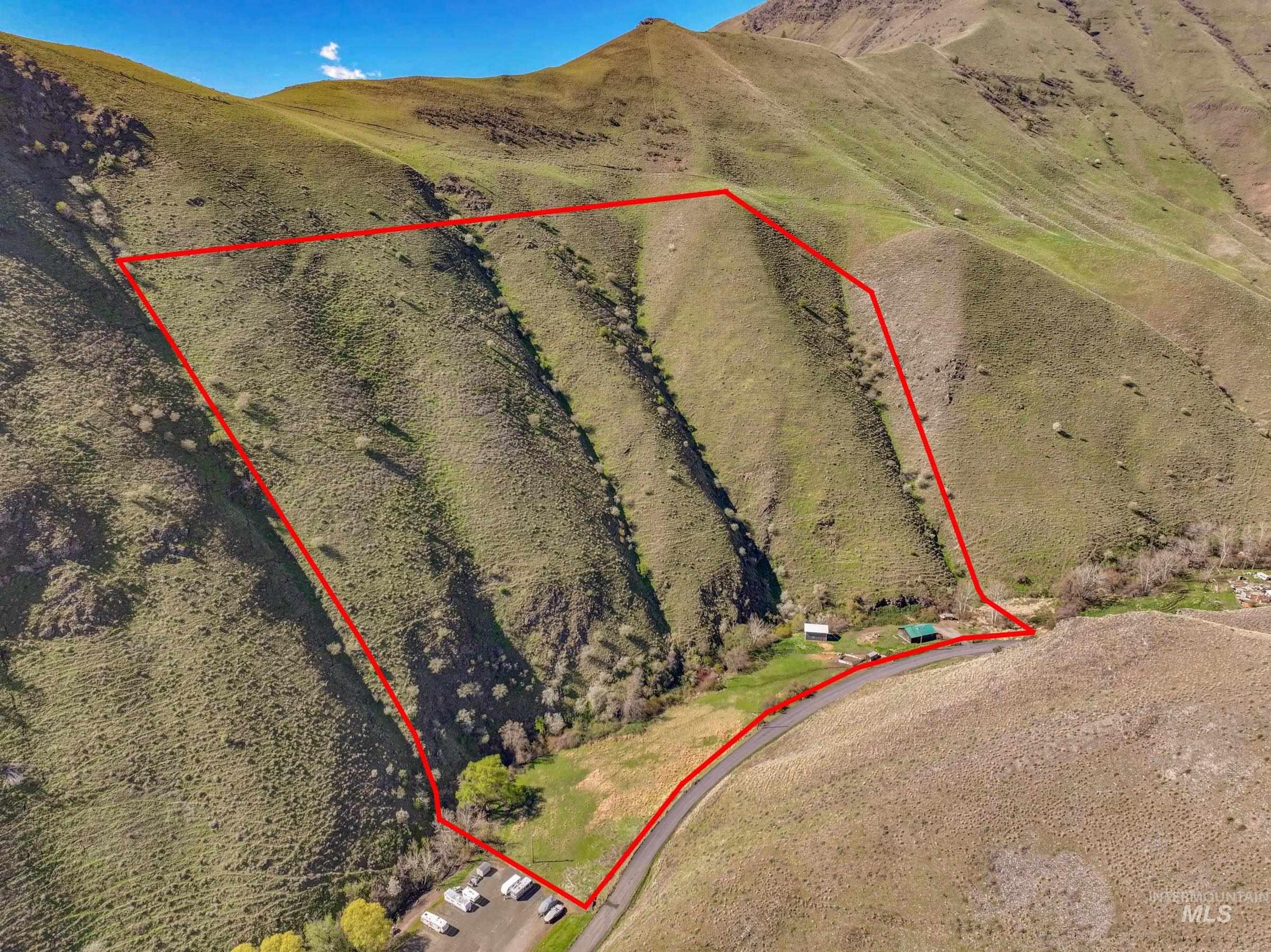 221 Seven Devils Road Riggins, ID 83549 - Photo 42 of 46 Aerial view of property and surrounding area featuring property boundaries highlighted and a mountain backdrop