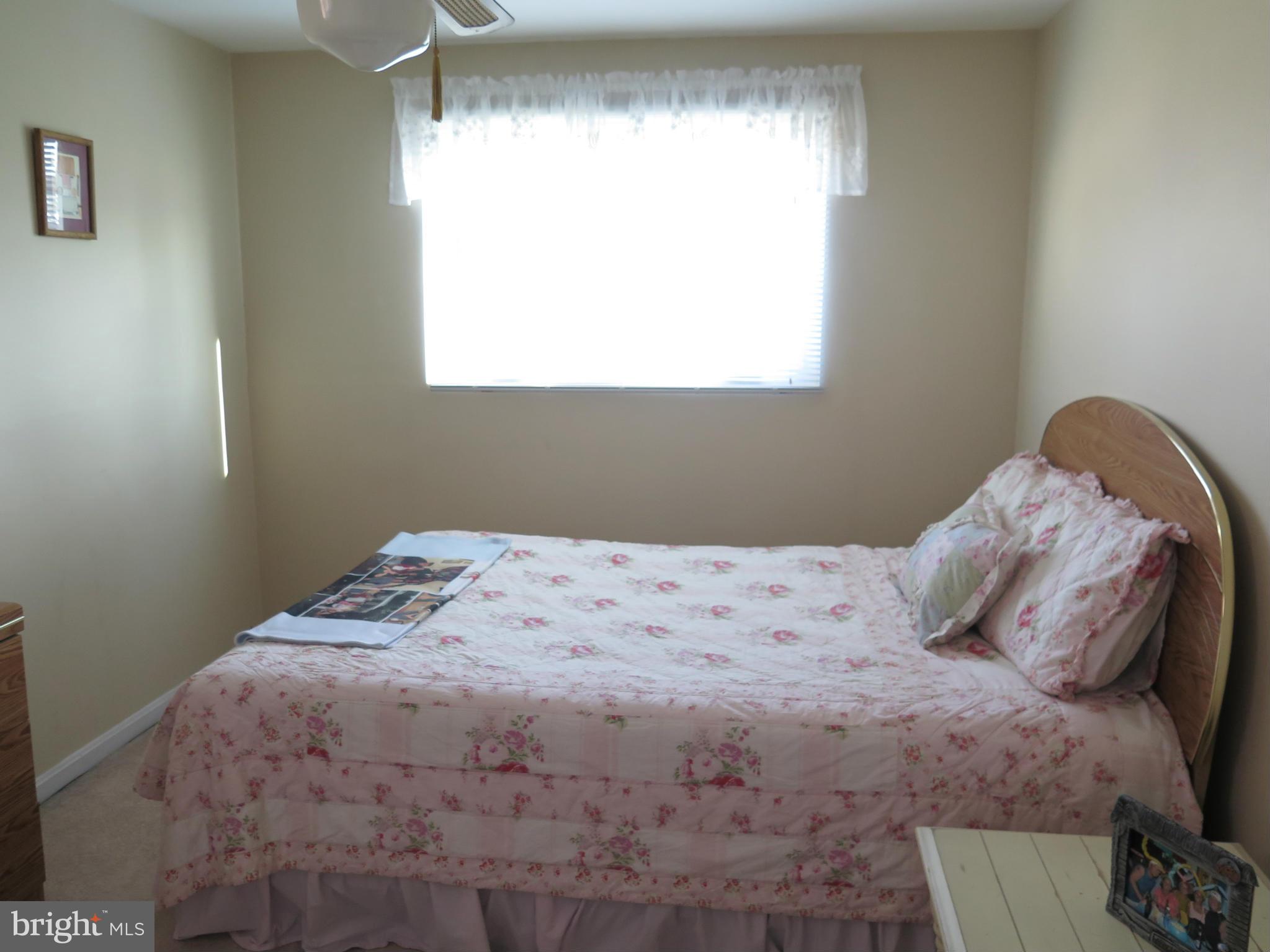 7867 Kavanagh Road Baltimore, MD 21222 - Photo 22 of 29 a bedroom with a bed and a window
