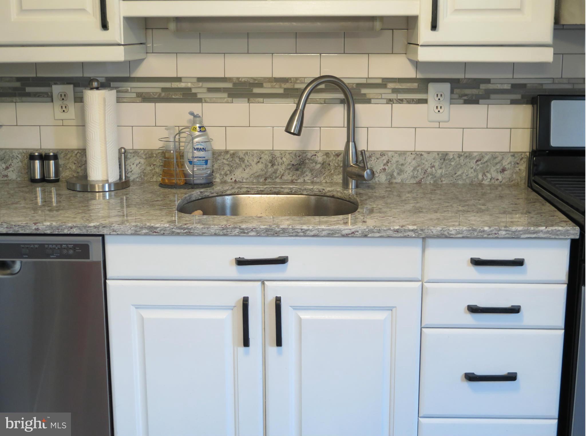 7867 Kavanagh Road Baltimore, MD 21222 - Photo 4 of 29 a kitchen with a sink and cabinets