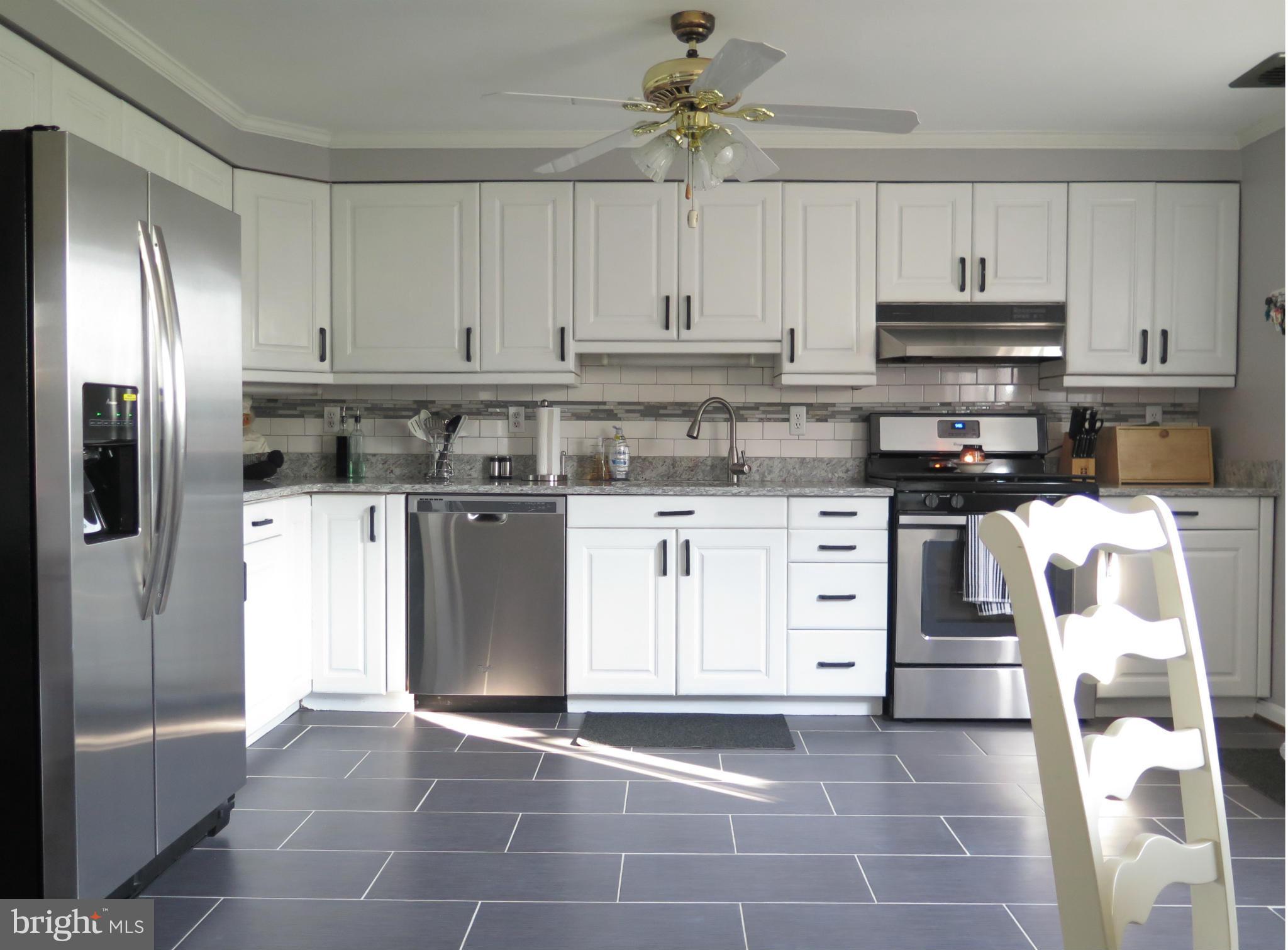 7867 Kavanagh Road Baltimore, MD 21222 - Photo 5 of 29 a kitchen with stainless steel appliances granite countertop a refrigerator and a stove