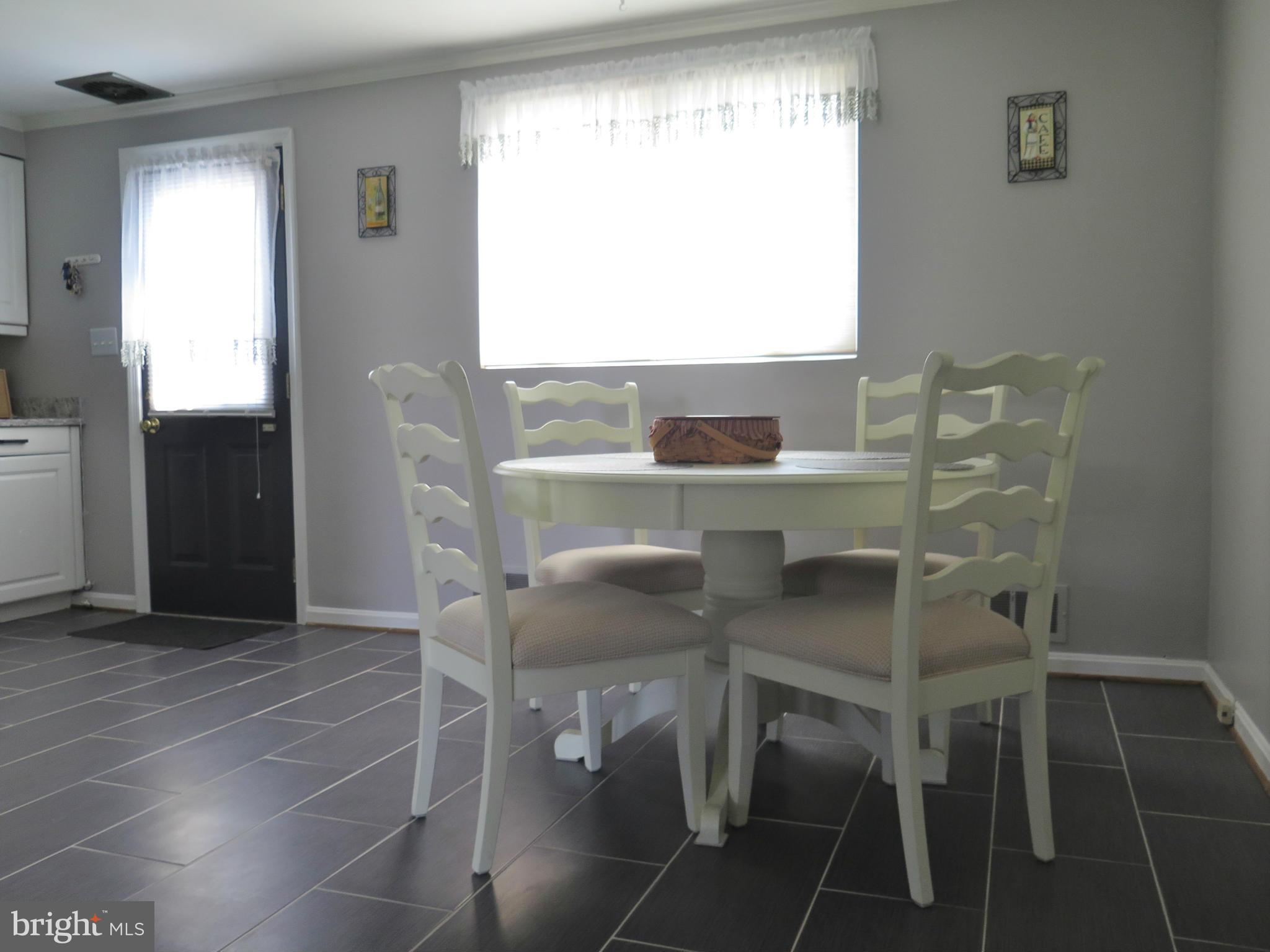 7867 Kavanagh Road Baltimore, MD 21222 - Photo 7 of 29 a view of a dining room with furniture and a window