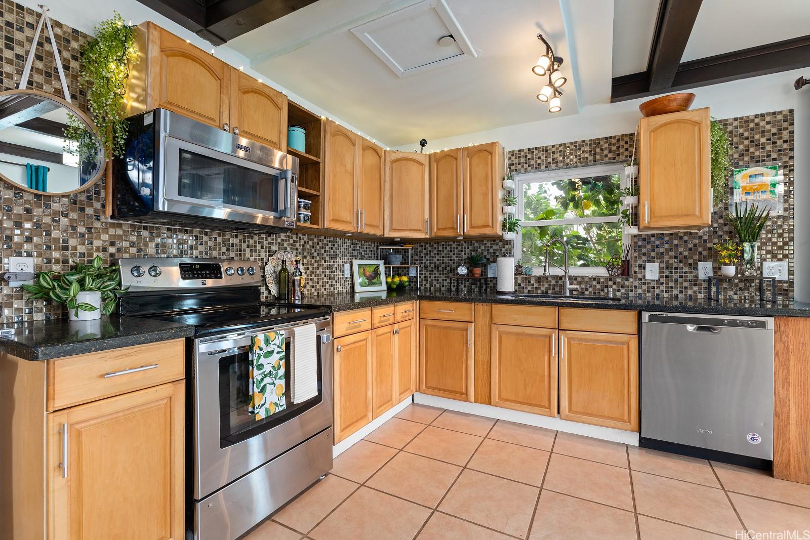 a kitchen with stainless steel appliances granite countertop a sink and cabinets