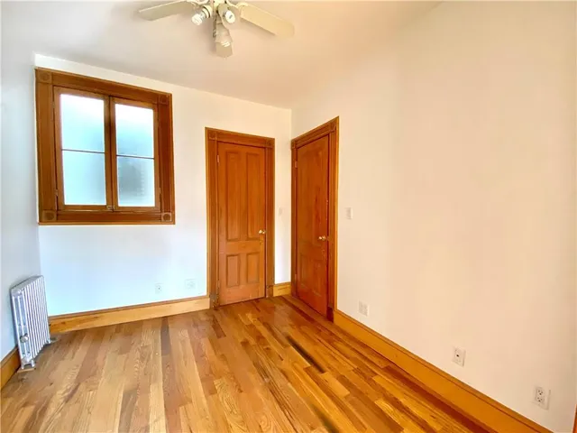 a view of hallway with wooden floor