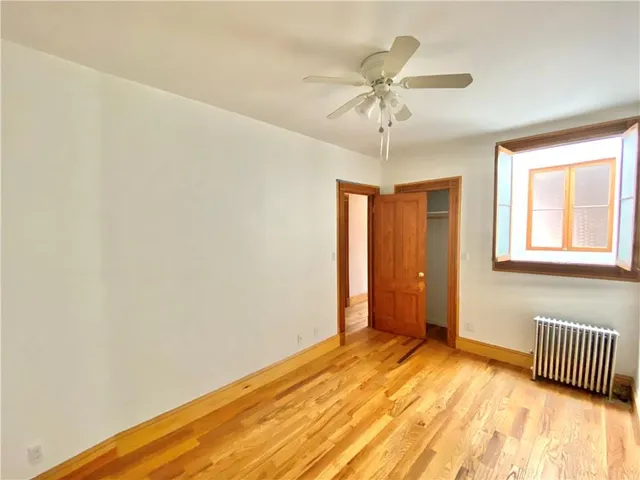 a view of empty room with a fireplace and windows